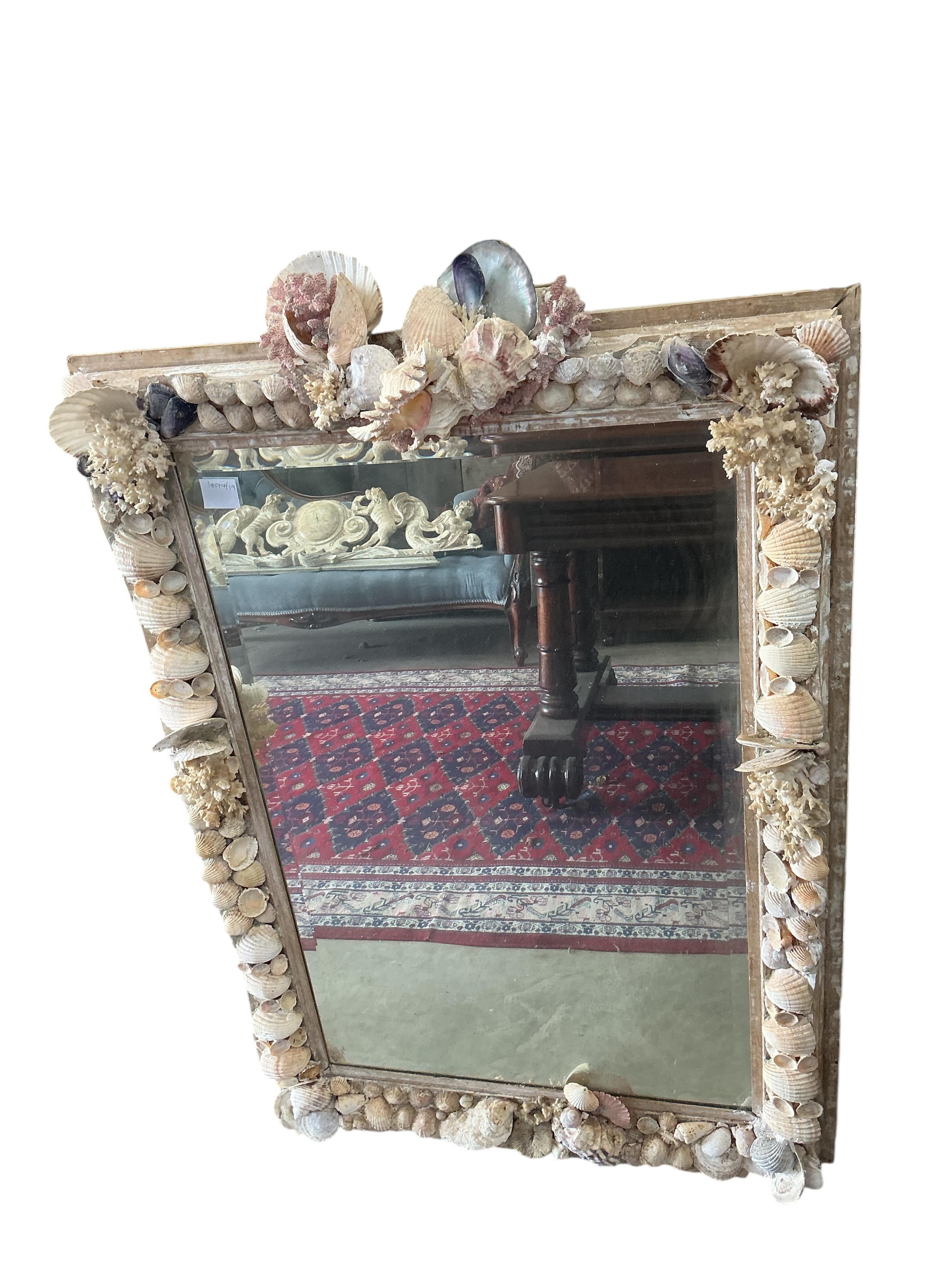 A rectangular shell encrusted wall mirror, width 77cm, height 114cm